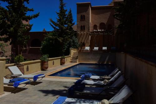 布马伦切斯皮埃尔旅馆的一个带躺椅的游泳池以及一座房子