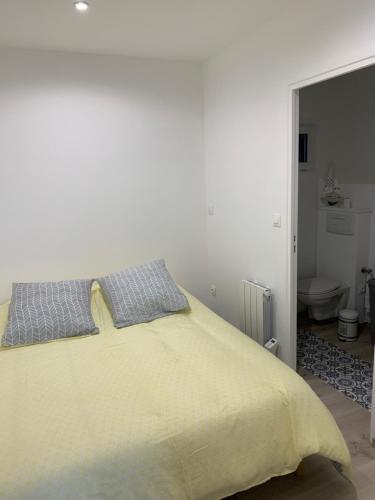 布赖迪讷Musica的一间卧室配有一张黄色毯子的床和一间浴室