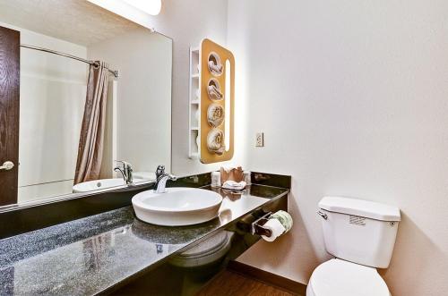 MoonEconomy Inn的白色的浴室设有水槽和卫生间。
