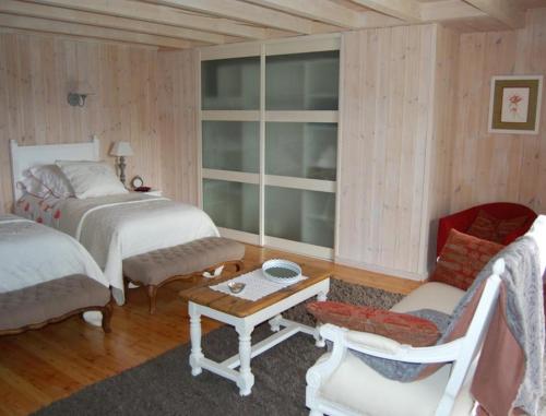 普华露拉夏里萨酒店的一间卧室配有两张床、一把椅子和一张桌子