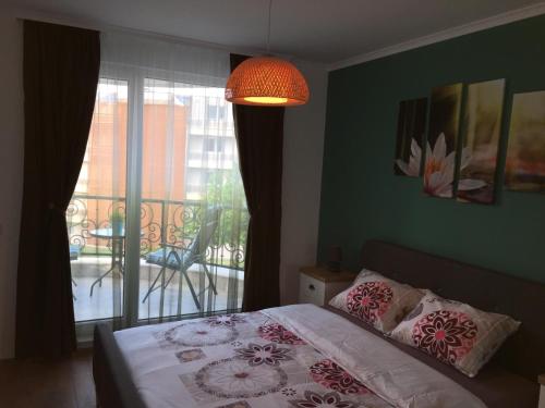 切尔诺莫雷茨Azur Apartment Deluxe的一间卧室设有一张床和一个阳台的窗户。