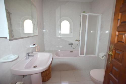 哈维亚Casa Mozart的一间带水槽、浴缸和卫生间的浴室