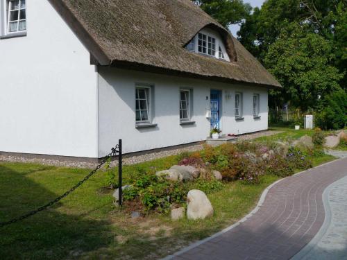 格罗斯齐克Haus Ketzenberg 1 - Lütt Mööv的白色的房子,有茅草屋顶和小径
