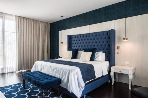 埃莫西约Marsella 45的一间卧室配有一张大床和蓝色床头板