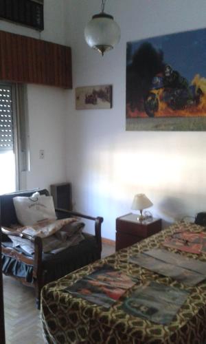 佩尔加米诺Casa habitacion的一间卧室配有一张床、一把椅子和一张桌子