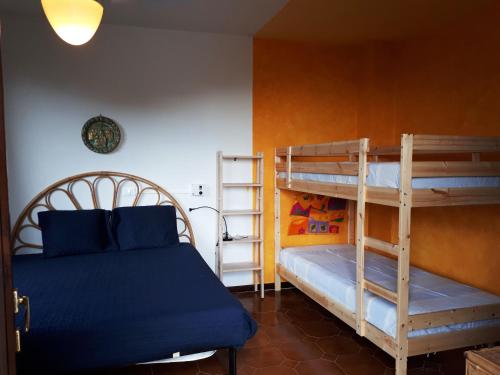 里奥内莱尔巴Nisportino的一间卧室配有两张双层床和一张蓝色的床。