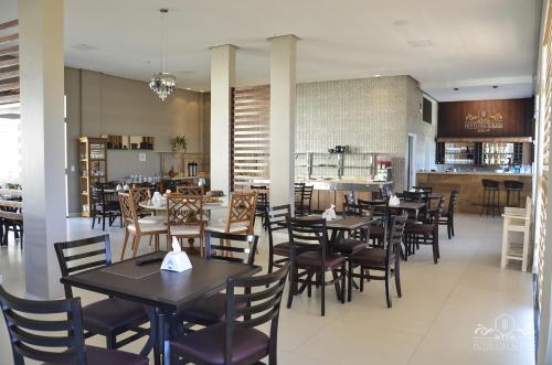 关那比Hotel das Torres的餐厅内带桌椅的用餐室