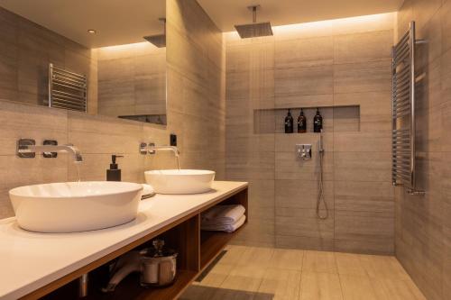 NesjavellirION Adventure Hotel, Nesjavellir, a Member of Design Hotels的一间带两个盥洗盆和淋浴的浴室