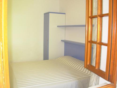 波蒙特Appartamento Il Nespolo的小房间设有床和窗户