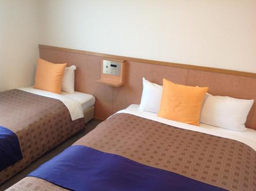 岛田1-2-3酒店客房内的一张或多张床位