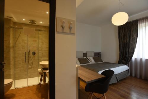 莫内利亚Hotel La Vigna的一间卧室配有一张床、淋浴和盥洗盆