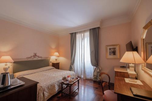 古比奥杜卡勒酒店的酒店客房设有床和窗户。