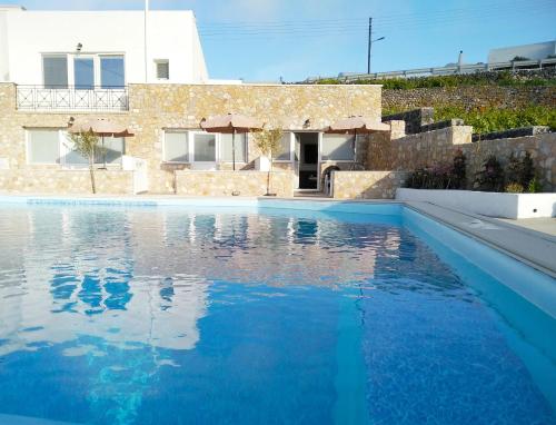 皮尔戈斯Aroma Cavas的一座房子前面的蓝色海水游泳池