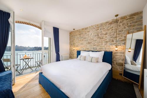 迪纳尔迪迪埃美丽儿餐厅酒店的酒店客房设有一张大床和一个阳台。