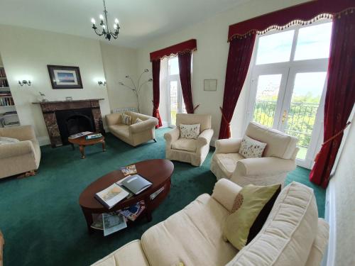 林顿西奈之家酒店的客厅配有白色家具和壁炉
