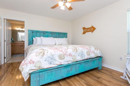 罗克波特Rockport Getaway的卧室配有蓝色的床和吊扇