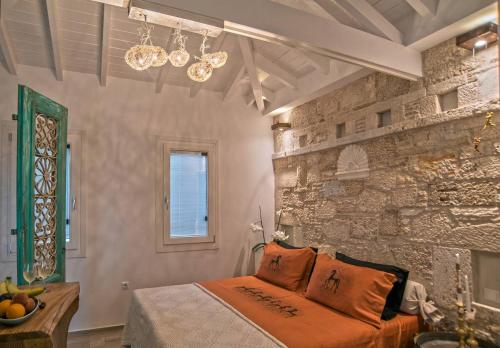 库卡里Eftopia Beachfront Studio的一间卧室设有一张床和石墙