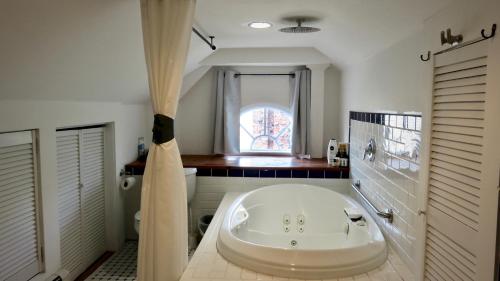 伊丽莎白GuestHouse的带窗户的浴室内的白色大浴缸