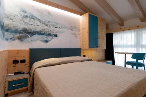 安达洛玛耀卡酒店的卧室配有一张床,墙上挂有绘画作品