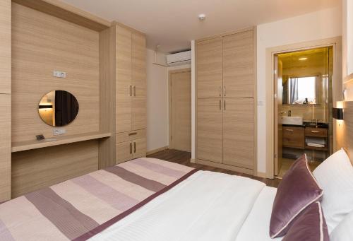 伊斯坦布尔Princess Residence的一间卧室配有一张带镜子和水槽的床