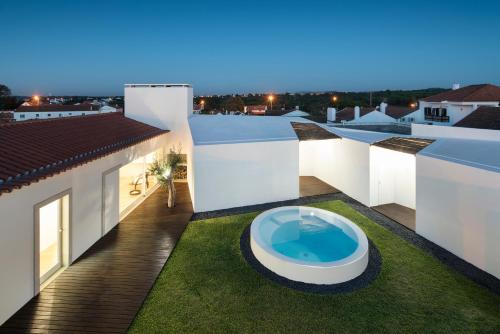 塞图巴尔Pátio do Meco的享有房子的景色,屋顶设有游泳池