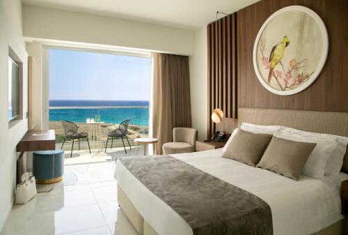 阿依纳帕NissiBlu Beach Resort的一间卧室配有一张床,享有海景