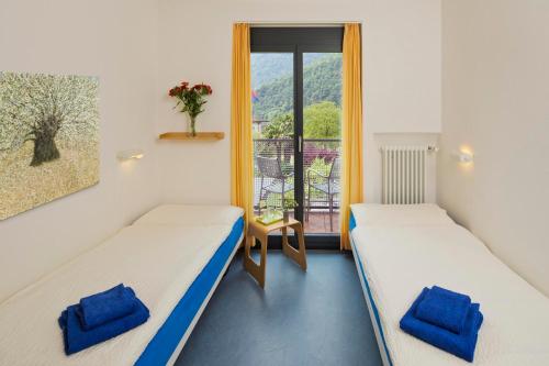 Coglio克里斯塔里纳生态酒店的带阳台的客房内的两张床