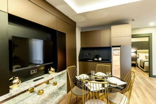 伊斯坦布尔阿宫殿套房公寓式酒店的厨房以及带桌椅的用餐室。