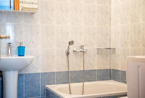 锡基亚family house nikos 2的带浴缸和盥洗盆的浴室