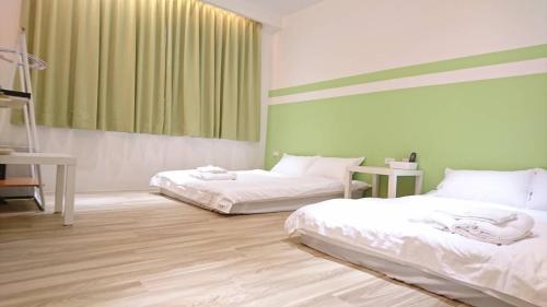 台南NO.14的绿白色客房内的两张床