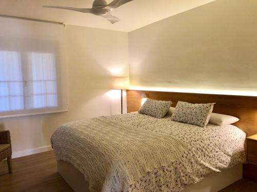 马贝拉Cabopino的一间卧室配有一张带吊扇的床