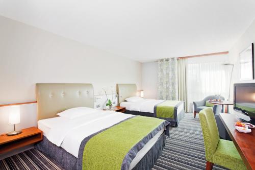 格拉特布鲁格苏黎世机场瑞享酒店的酒店客房设有两张床和一台平面电视。