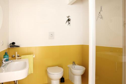 那不勒斯多米达摩酒店的浴室配有盥洗盆、卫生间和浴缸。