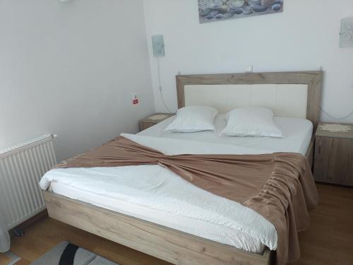 阿列谢尼Casa Raluca的一间卧室配有一张带白色床单的大床