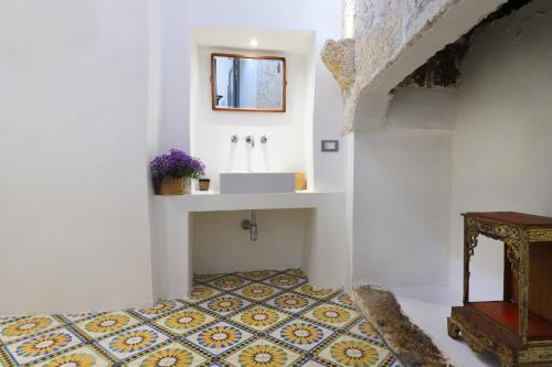 斯佩基亚Masseria delle Pecore的一间带水槽的浴室,铺有瓷砖地板。