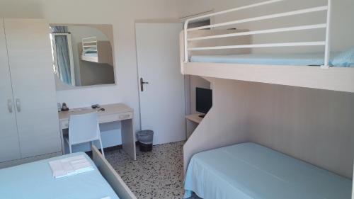 阿祖罗港Albergo Bel Tramonto的小房间设有双层床和书桌