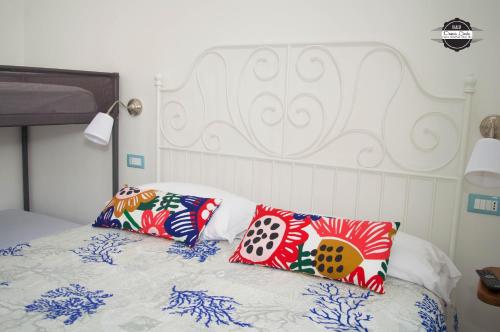 伊斯基亚Domus Linda B&B的床上有色彩缤纷的枕头