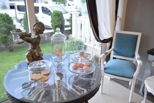 乐托卡亚Epavlis Luxury apts的一张带食物的玻璃桌和雕像