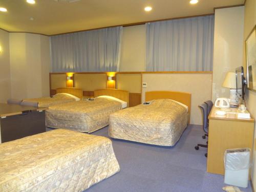 北九州浅野酒店的一间酒店客房,房间内设有三张床