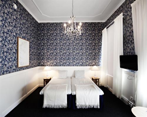 瑟德港第一斯塔特酒店的一间卧室配有一张床和一个吊灯
