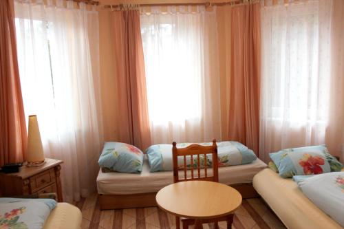 波别罗沃Pension Dom Wypoczynkowy Ulla的客房设有两张床、一张桌子和一扇窗户。