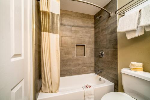 唐尼唐尼丽晶汽车旅馆的浴室配有白色浴缸和卫生间。