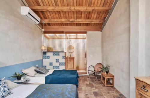 屏东县大厝護龍的一间卧室设有两张床和木制天花板