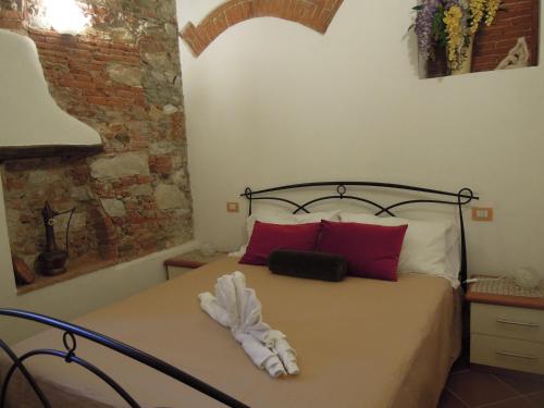 彼得拉桑塔Corte Navari - Loft Principe Filippo的一间卧室配有红色和白色枕头的床