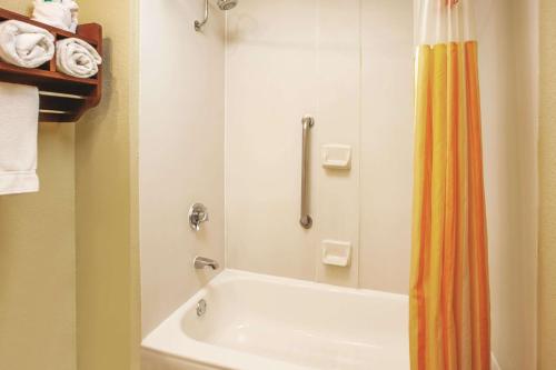 坎顿Baymont by Wyndham Canton的带浴缸和淋浴帘的浴室