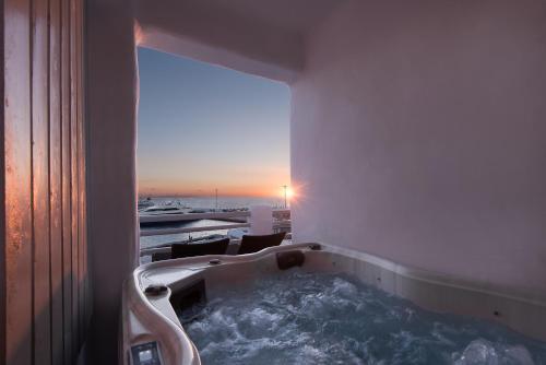 米克诺斯城Riva Suites - Adults Only的享有美景的客房内设有浴缸。