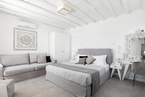 米克诺斯城Riva Suites - Adults Only的白色卧室配有床和沙发
