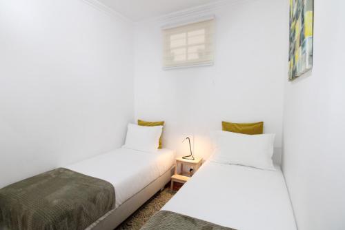 里斯本塞特里奥斯公寓，靠近动物园里斯本/免费无线网络的白色墙壁客房的两张床