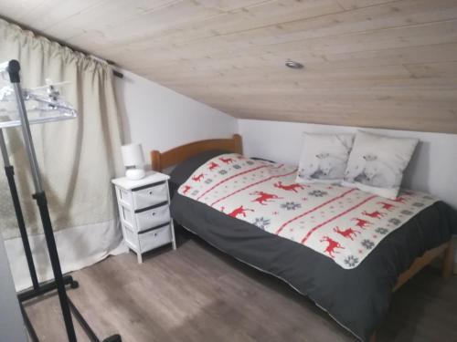Enchastrayeschambre les ormes的一间卧室设有一张床和木制天花板