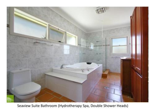 卧龙岗南苑宾馆的带浴缸、卫生间和盥洗盆的浴室